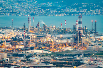 Oil refinery factory on the sea in Izmit, Turkey. Petrochemical plant structure on manufacturing oil refinery. Tupras Izmit petroleum refinery. Tupras is Turkey's largest oil refinery. - obrazy, fototapety, plakaty