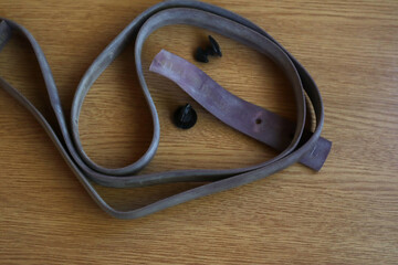 Old esmarch plait on a wooden table