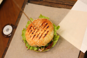 Burgers with lettuce, cutlet and tomatoes. Burgers in the restaurant. Burgers close up. Fast food, wrong food. Fat. Obesity.