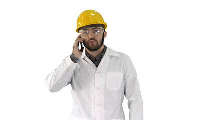 Engineer in protective glasses and hat walking, taking on the phone on white background.