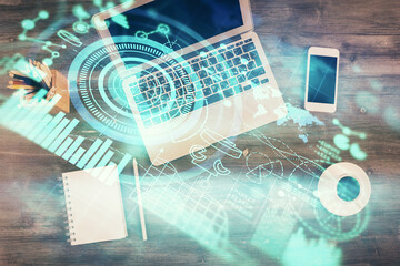 Business theme hologram drawings over computer on the desktop background. Top view. Multi exposure. Concept of international connections.