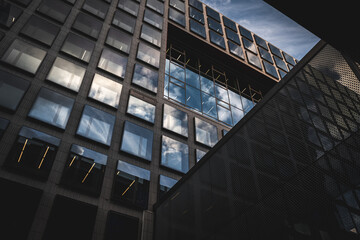 Upwards angle look up shot of big modern building with sky reflection on the windows