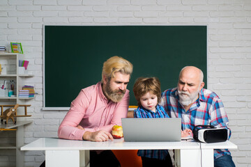 Father, Grandfather and child son together. Child reading for education. Preschool pupil.