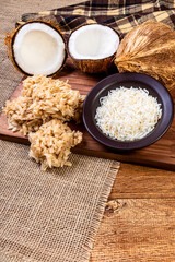 Cocada on the wooden table. Traditional coconut sweet from Brazil.