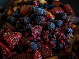 Close up of frozen mixed fruit - berrie - red currant, raspberry, strawberry, blackberry, blueberry