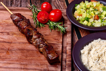 Kebab - Grilled meat on a cutting board, with flour and vinaigrette salad
