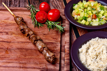 Kebab - Grilled meat on a cutting board, with flour and vinaigrette salad