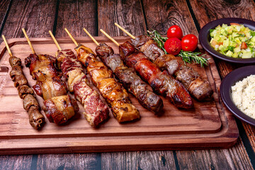 Kebab - Grilled meat on a cutting board, with flour and vinaigrette salad