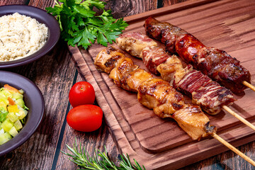 Kebab - Grilled meat on a cutting board, with flour and vinaigrette salad