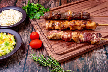 Kebab - Grilled meat on a cutting board, with flour and vinaigrette salad