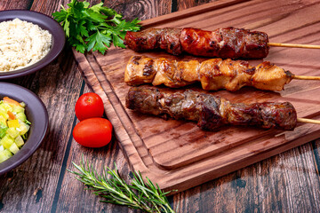 Kebab - Grilled meat on a cutting board, with flour and vinaigrette salad