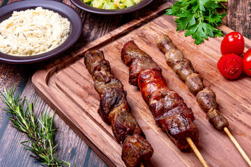 Kebab - Grilled meat on a cutting board, with flour and vinaigrette salad