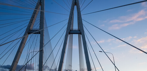 Cable bridge against the sky back, summer day