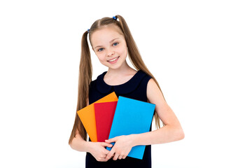Happy cute smiling cheerful child girl in school uniform holding books.