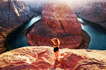 American female tourist on Grand canyon. Travel Lifestyle success concept. Young Woman enjoying view of Horseshoe bend.