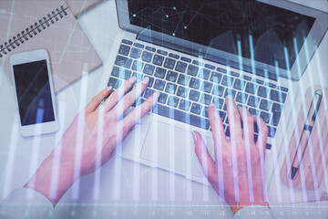 Plakat Double exposure of woman hands working on computer and forex graph hologram drawing. Top View. Financial analysis concept.
