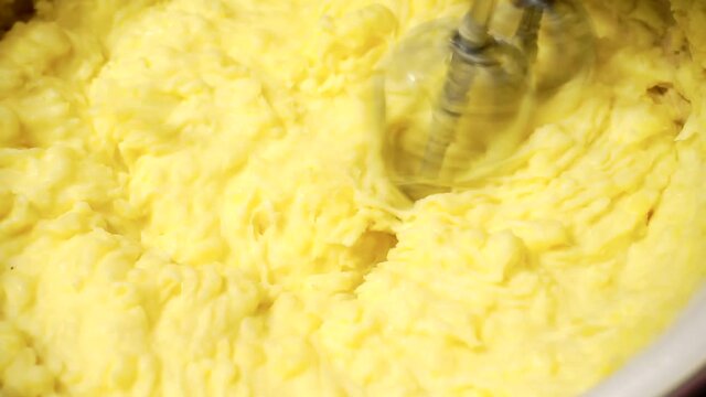 an electric mixer whips the mashed potatoes.close-up