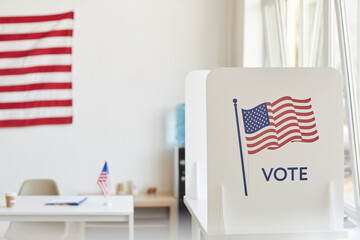 Background image of voting booths decorated with American flags at empty polling station, copy space