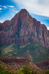 Majestic mountain at entrance to Zion NP showing colorful rock face with blue sky  and soft clouds