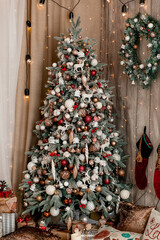Christmas, New Year interior decorated Christmas gifts with ribbons, wreath, pillows , candles and...