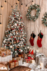 Christmas, New Year interior decorated Christmas gifts with ribbons, wreath, pillows , candles and...