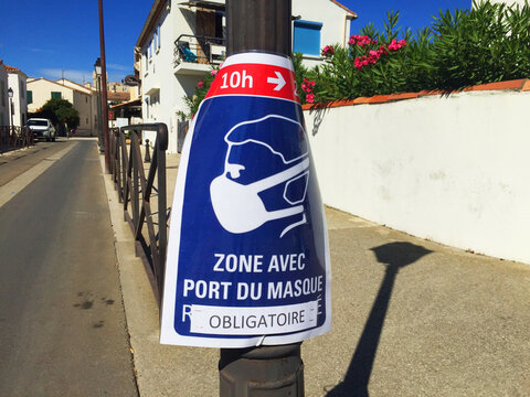 French Sign Reads 'Zone Where Wearing A Mask Is Obligatory' For Coronavirus In Saintes Maries De La Mer