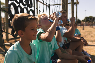 Group of kids drinking water at a boot camp