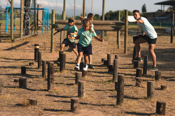 Kids walking through a obstacle course at a boot camp