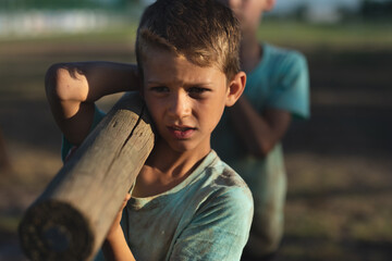 Boys carrying log at boot camp