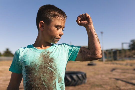 Boy flexing his bicep at a bootcamp