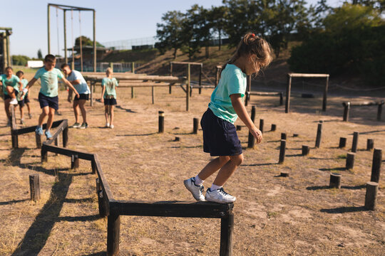 Group of kids walking through a obstacle course at a boot camp