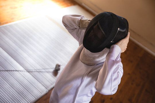 Man wearing fencing outfit 