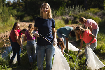 Volunteers cleaning up river in the countryside