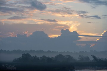rising sun hidden by clouds
