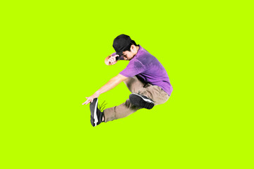 Man jump while performing break dance on studio