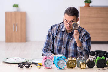 Young male watchmaker working in the workshop