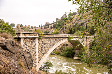 The beautiful bridge, Puenta de Alcantara, that leads into the historic city of Toledo, Spain.
