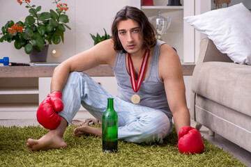 Male ex-champion boxer suffering from alcoholism at home