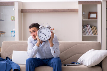 Young male employee working from the house