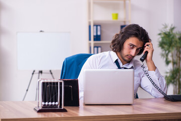 Drug addicted male employee working in the office
