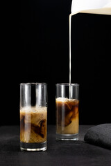 glass of coffee liqueur on black background