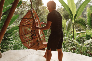 Young couple relaxing in comfortable chairs in the garden