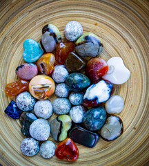 colorful stones in a wood bowl