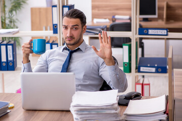 Young male employee unhappy with excessive work