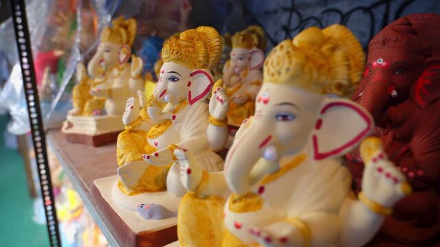 Ganesha Ganapati Idols kept in shelves during festival utsav for sale in an idol shop in Mumbai India