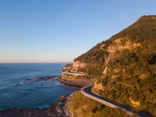 Aerial view of road around the cliff in the coastline.