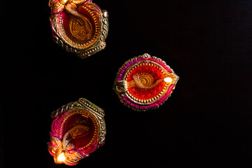 Decorative colourful diya lamps lit during diwali festival. 