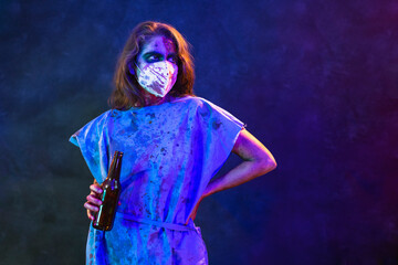 Halloween zombie with coronavirus Woman wearing face mask Kn95 protective for Covid-19 holding a beer botthe. Horror infection concept