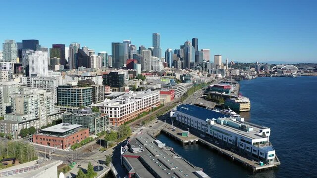 Drone footage of the cruise terminal in Seattle, waterfront, piers, empty Alaskan Way with skyscrapers, during the pandemic