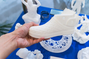 hand with 3d printed shoe figure close-up